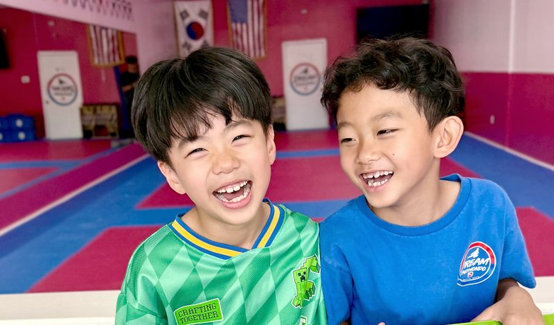 Two boys laughing together at a birthday party